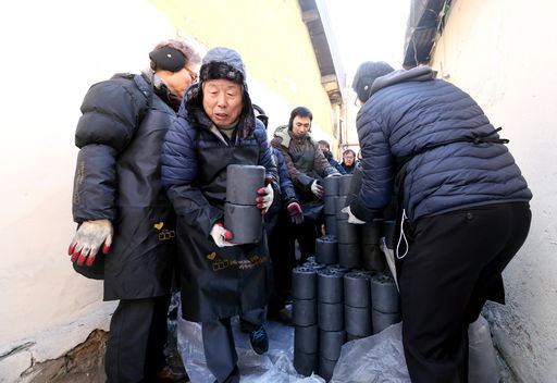 유인태 국회사무총장과 국회사무처 직원 60여명이 27일 서울 영등포 일대의 좁은 골목길을 누비며 저소득가구에 연탄을 직접 전달하고 있다.(사진=김지범 촬영관)